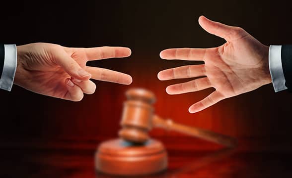 A legal battle between two people in costumes, represented with rock-paper-scissors