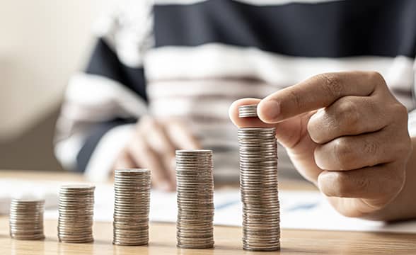 Person stacking coins