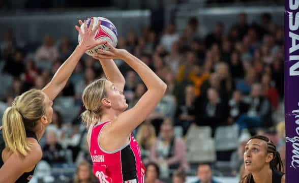 A Netball Australia player taking a shot.