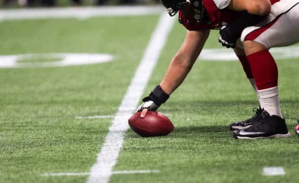 A NFL player preparing to throw the ball.