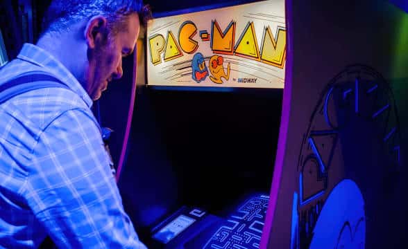 A person playing PAC Man Arcade.