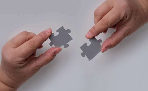 Two puzzle pieces dovetailing together.