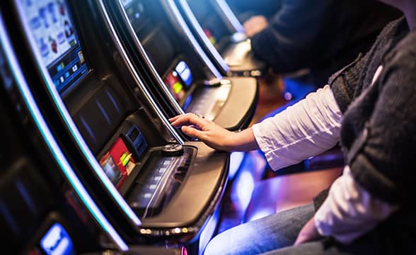 A person playing on a slot machine