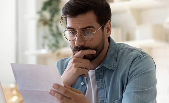 A person is carefully reading a letter