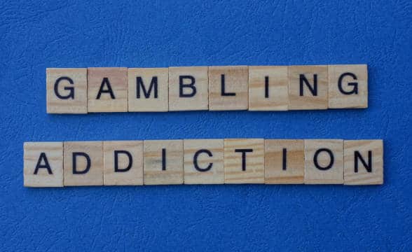 Problem gambling spelt with wooden cubes.