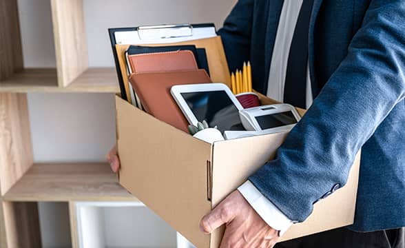 A worker packs his possessions before leaving a company