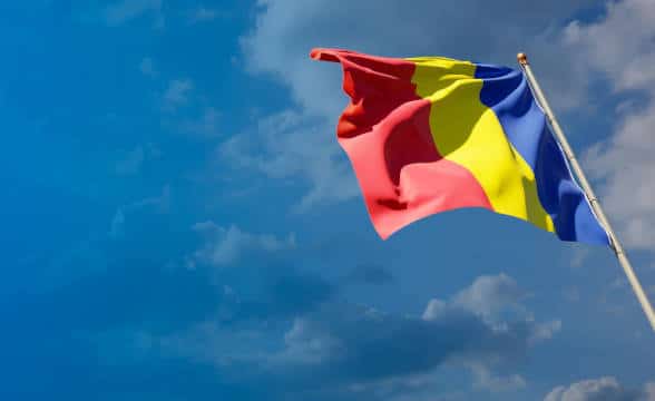 Romanian national flag flying in the air.