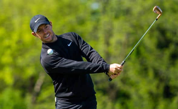 Rory McIllroy taking a swing in a game of golf.