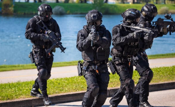 A swat team moving in tactical group.