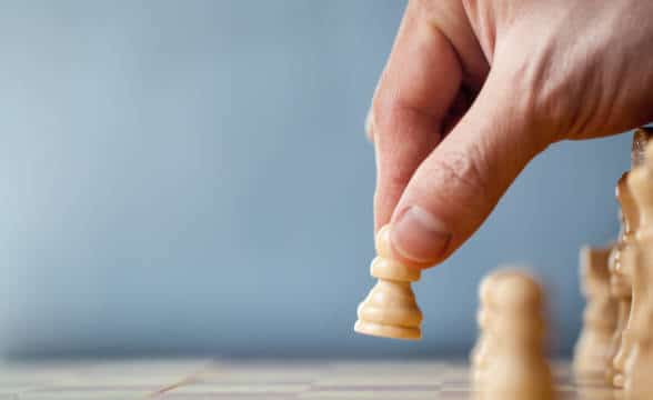 A pawn being moved by a person.