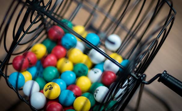 A bingo balls cage full of colorful balls