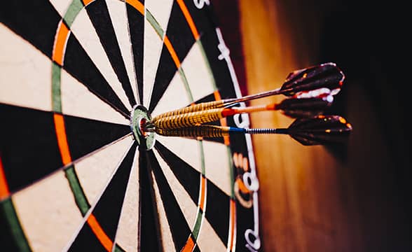 A darts board with three darts