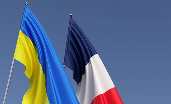 The flags of Ukraine and France next to one another