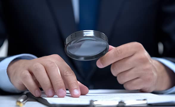 A businessmen carefully examines a document