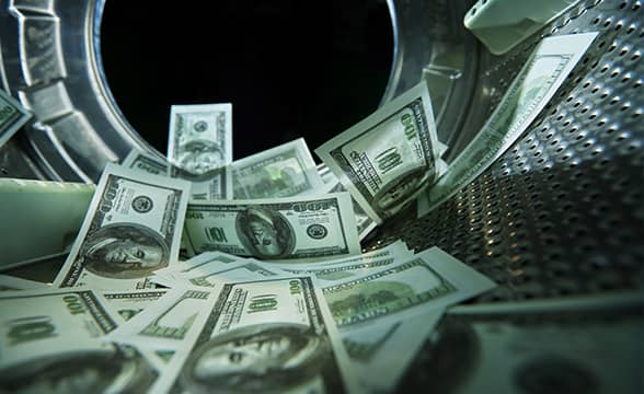 Dollar bills being laundered in a washing machine