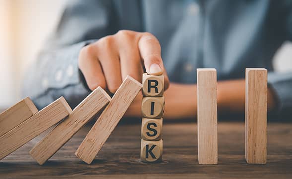 A man manages risk by stopping a row of tiles from falling