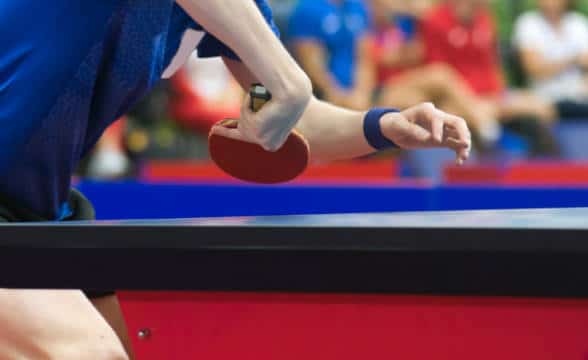 A player preparing to take a shot at table tennis.