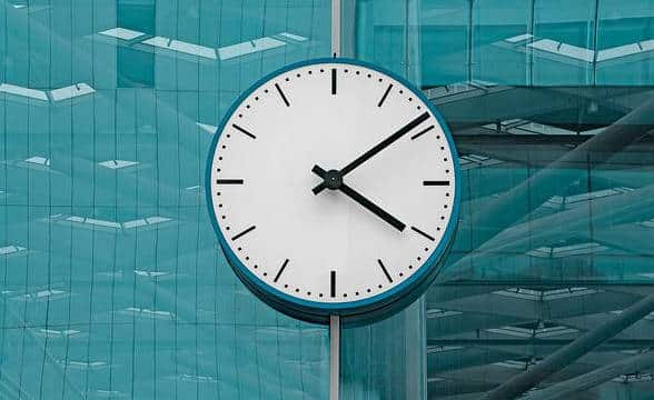 A clock showing the time on a building or on a pole.