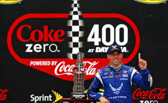 A NASCAR driver celebrating Coke Zero 400 win.