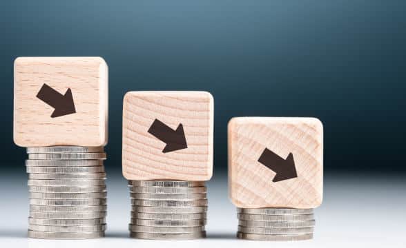 Coins in piles exemplifying decline in financial results.