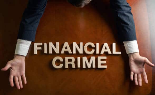 Financial crime spelt out on a desk.