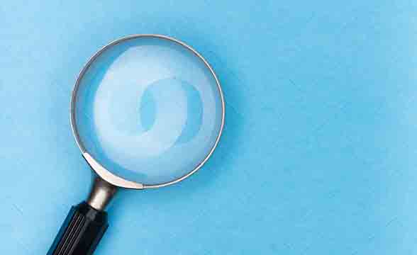 A magnifying glass on a blue background