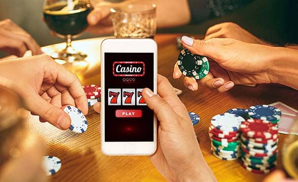 A person plays casino games on their mobile phone