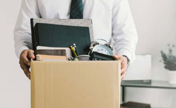 A man resigning and packing his desk.