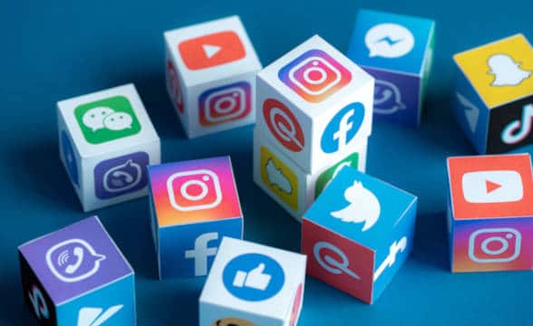 Social media icons on physical cubes.