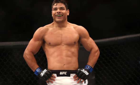 A UFC fighter standing arms akimbo.