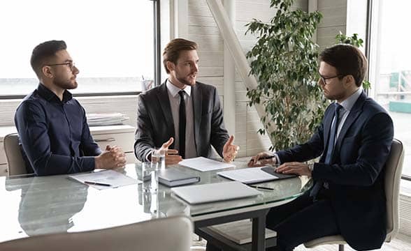 Three businessmen in a luxurious office