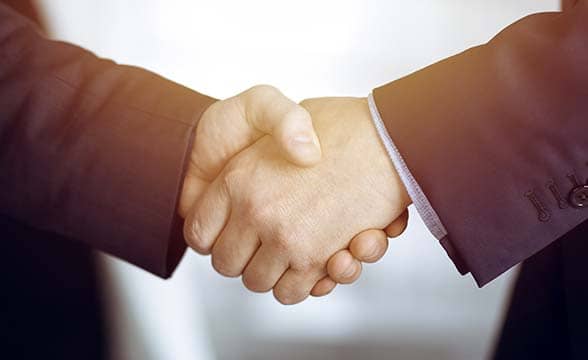 Two businessmen shake hands