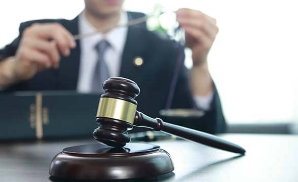 A judge with a judge's mallet in front of him