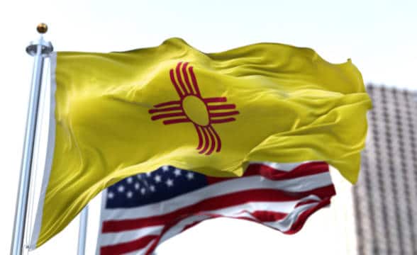 New Mexico's state flag waving next to US's state flag.