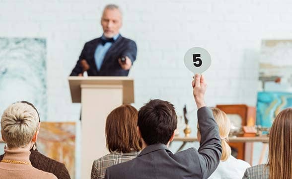 A person bids on an item during an auction