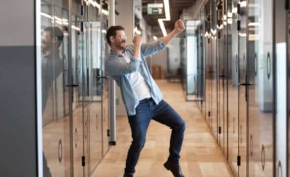 A man dancing and cheering at something.