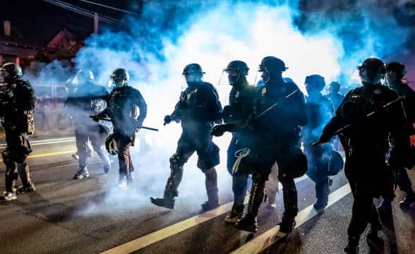 A bunch of riot police in the streets.