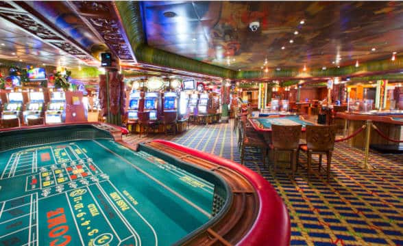 An empty casino gaming floor and its tables.