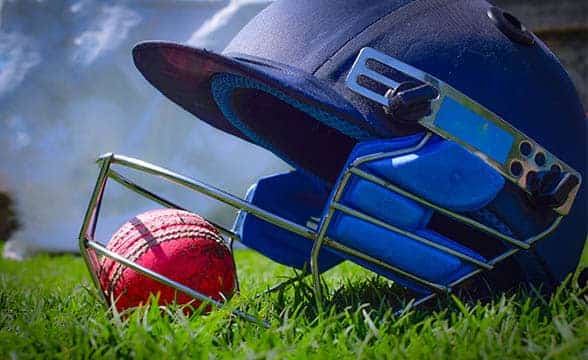 A cricket helmet and a ball