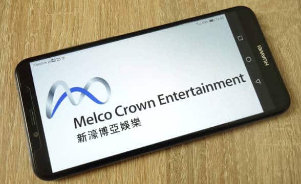 Melco Crown Entertainment's logo on a mobile phone.