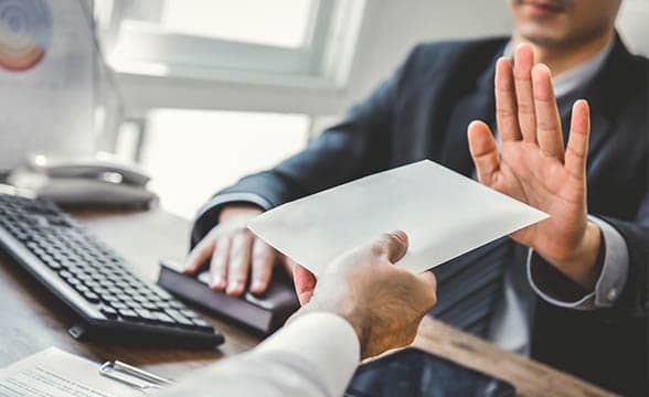 Businessman refuses to take an envelope