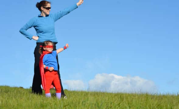 A mother and a child dressed up as superheroes.