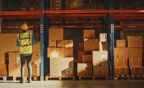 A warehouse worker checking the inventory.