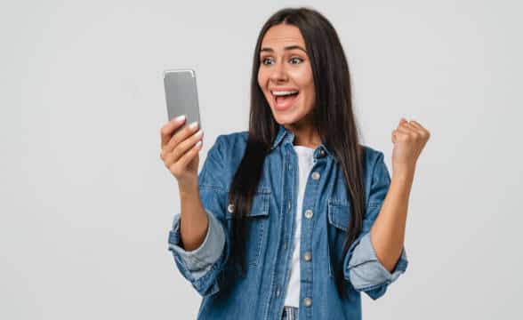 Woman happy at her smartphone.