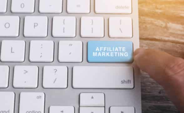 Close up photo of a finger pressing an affiliate marketing button on a keyboard