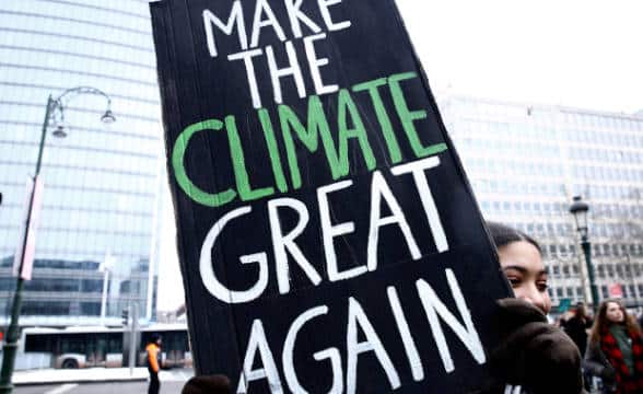 Climate activist holding a banner.