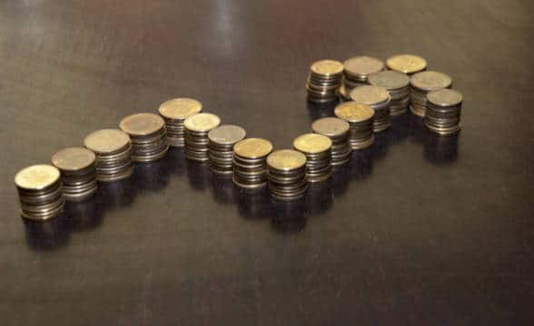 Coins stacked on top of each other in the form of an arrow pointing up