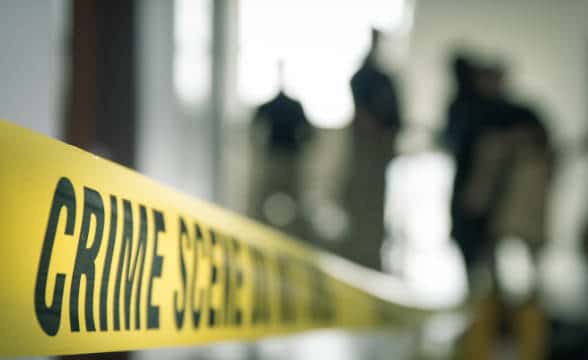 A yellow tape at a crime scene.