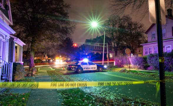 A crime scene with a car parked outside a house.