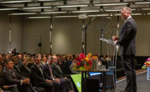 Crown Resorts CEO Ciarán Carruthers on stage in front of audience